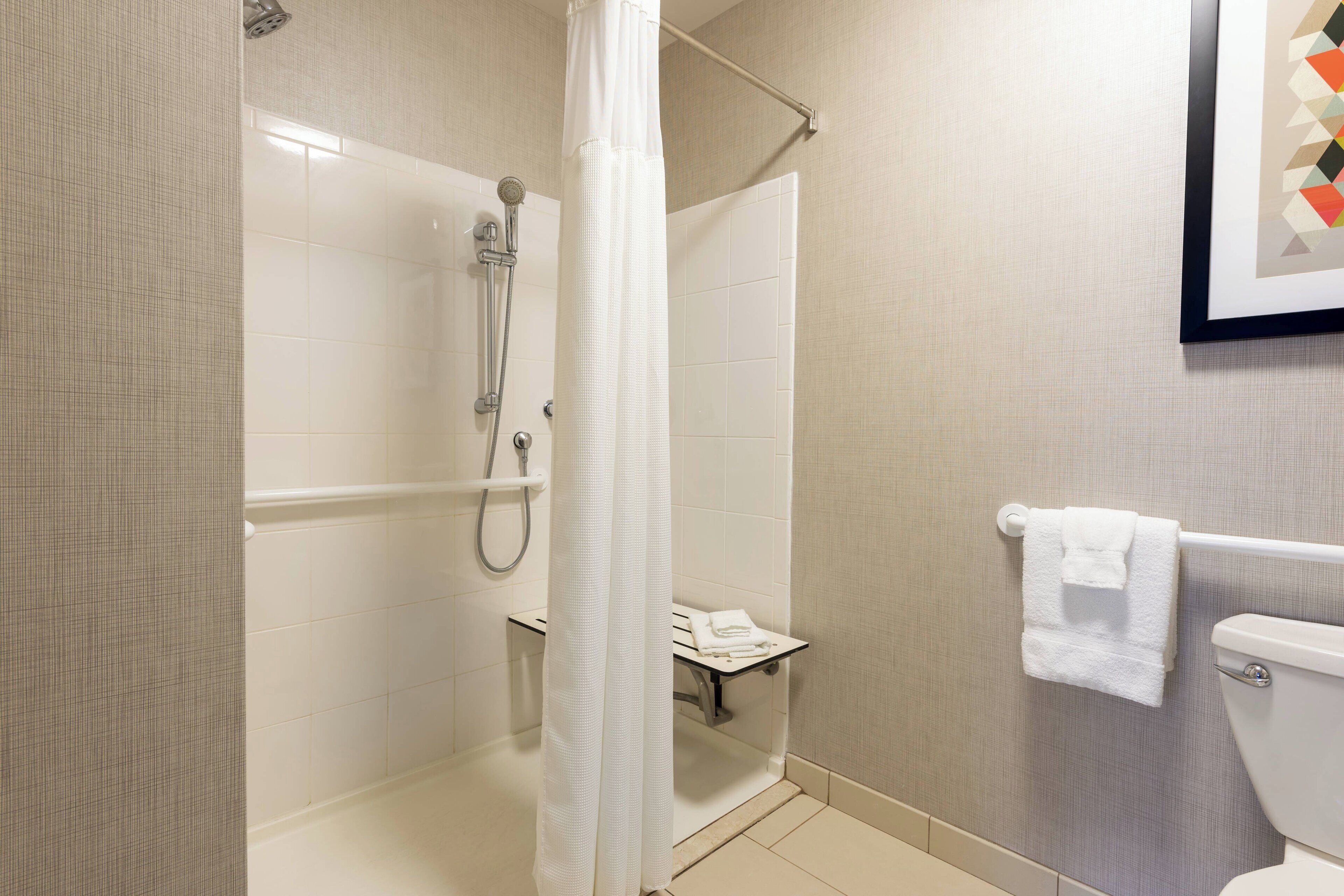 combined shower/bathtub, designer toiletries, hair dryer, towels