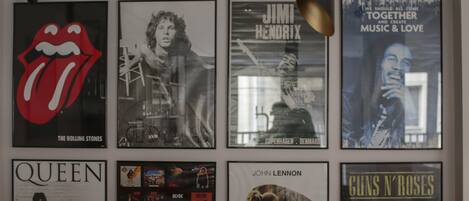 A wall with framed posters of various bands and musicians.