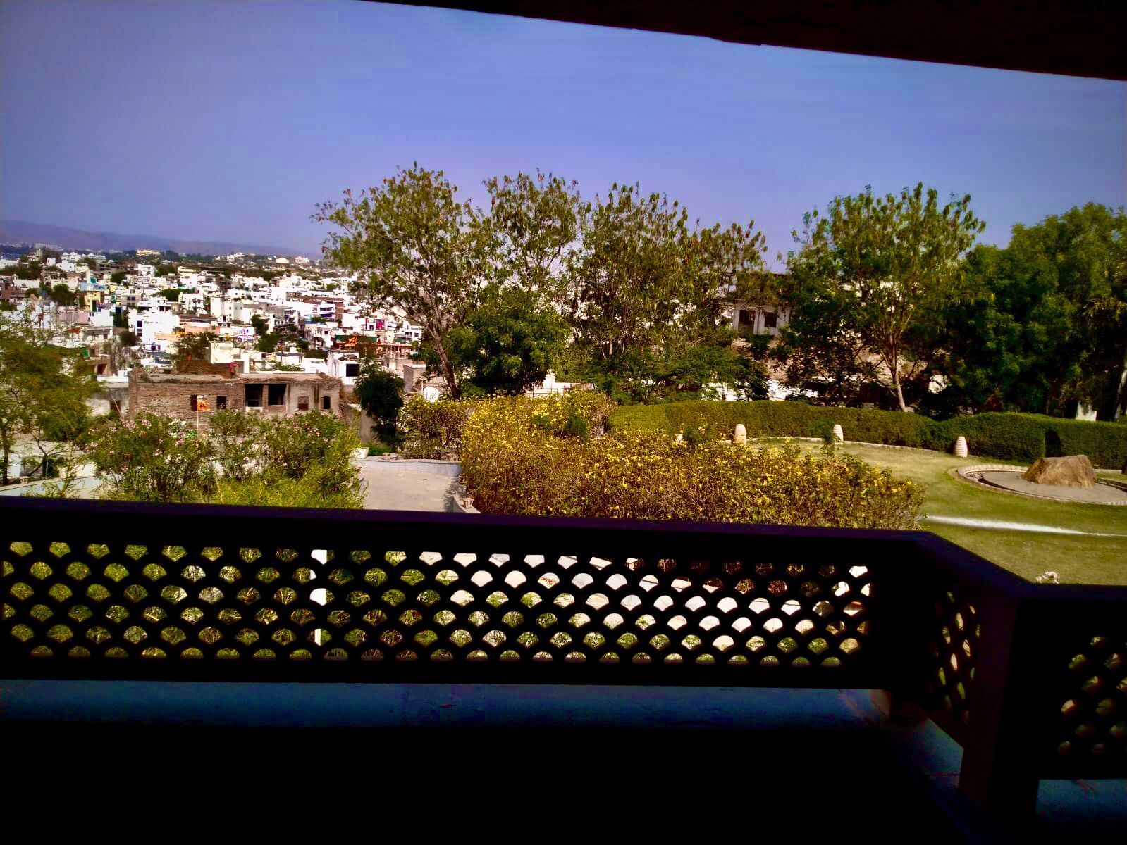 A view of a town with buildings and greenery.