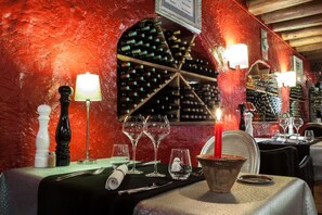 Enjoy a romantic dinner in this intimate dining area with a beautifully set table and wine selection.