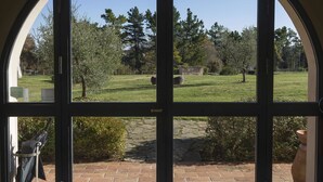 A large arched window with a clear view of a grassy yard and trees. - Le Sodole Country Resort & Golf (Pontedera)