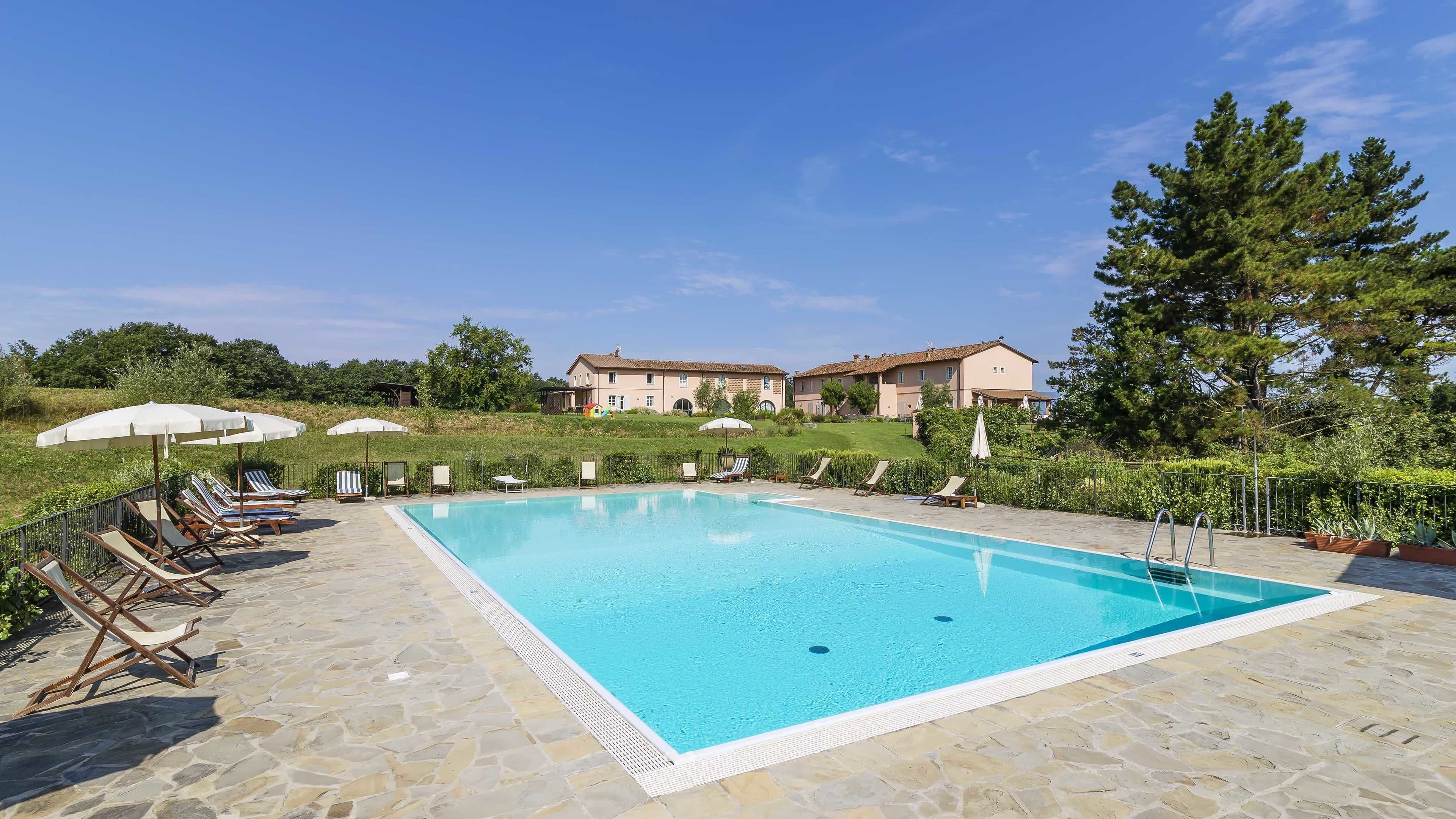 seasonal outdoor pool, pool umbrellas, pool loungers