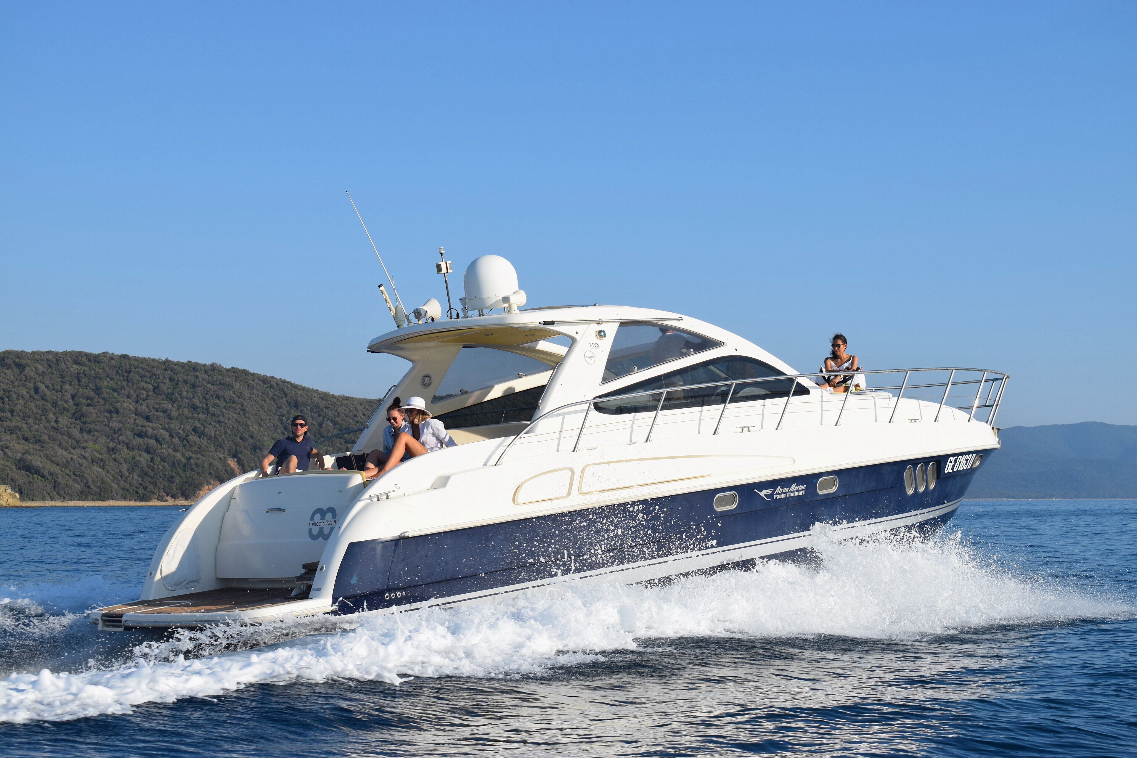 A yacht with a spacious deck, a covered area, and a helipad.