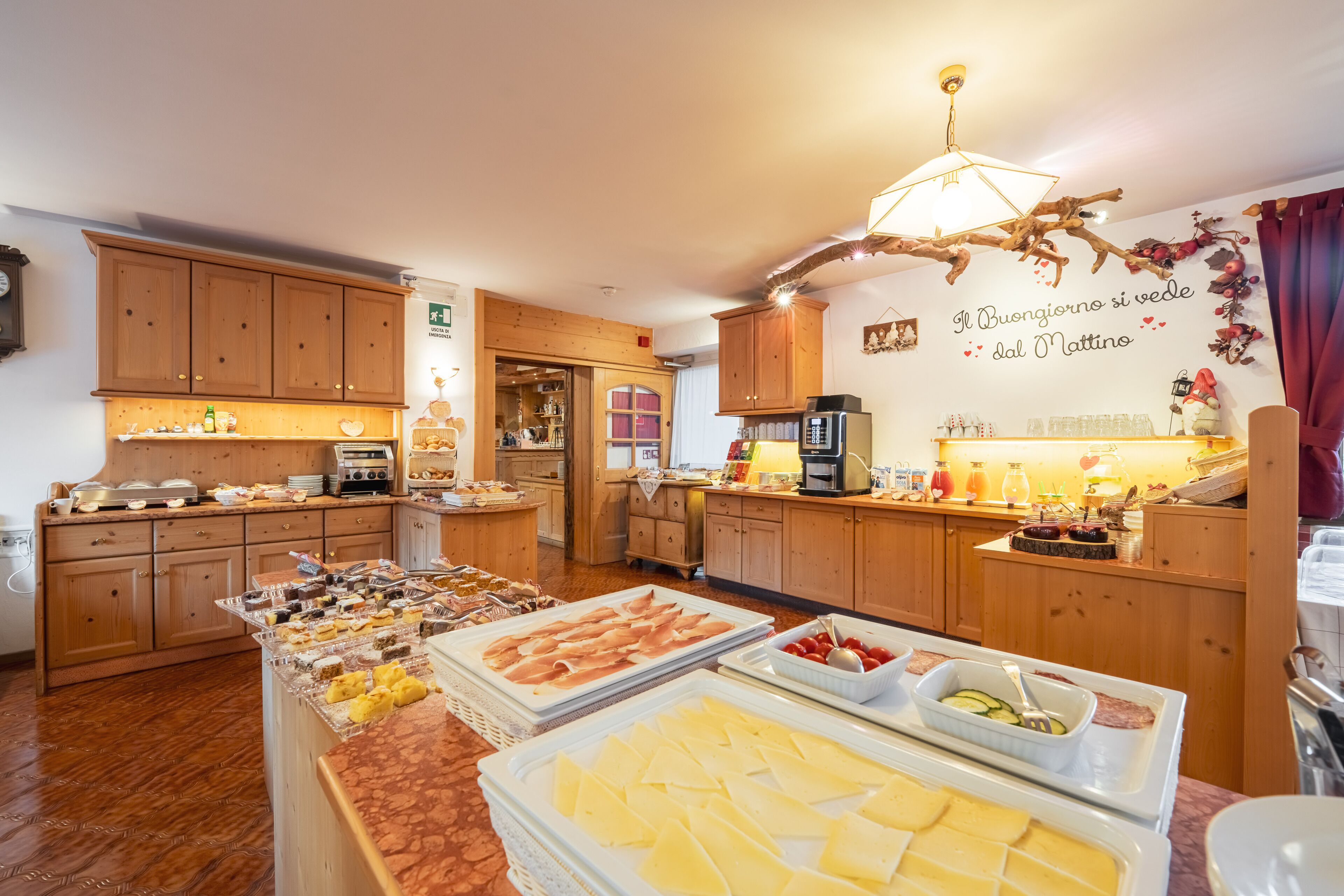 A breakfast buffet with various food items and a wooden interior.