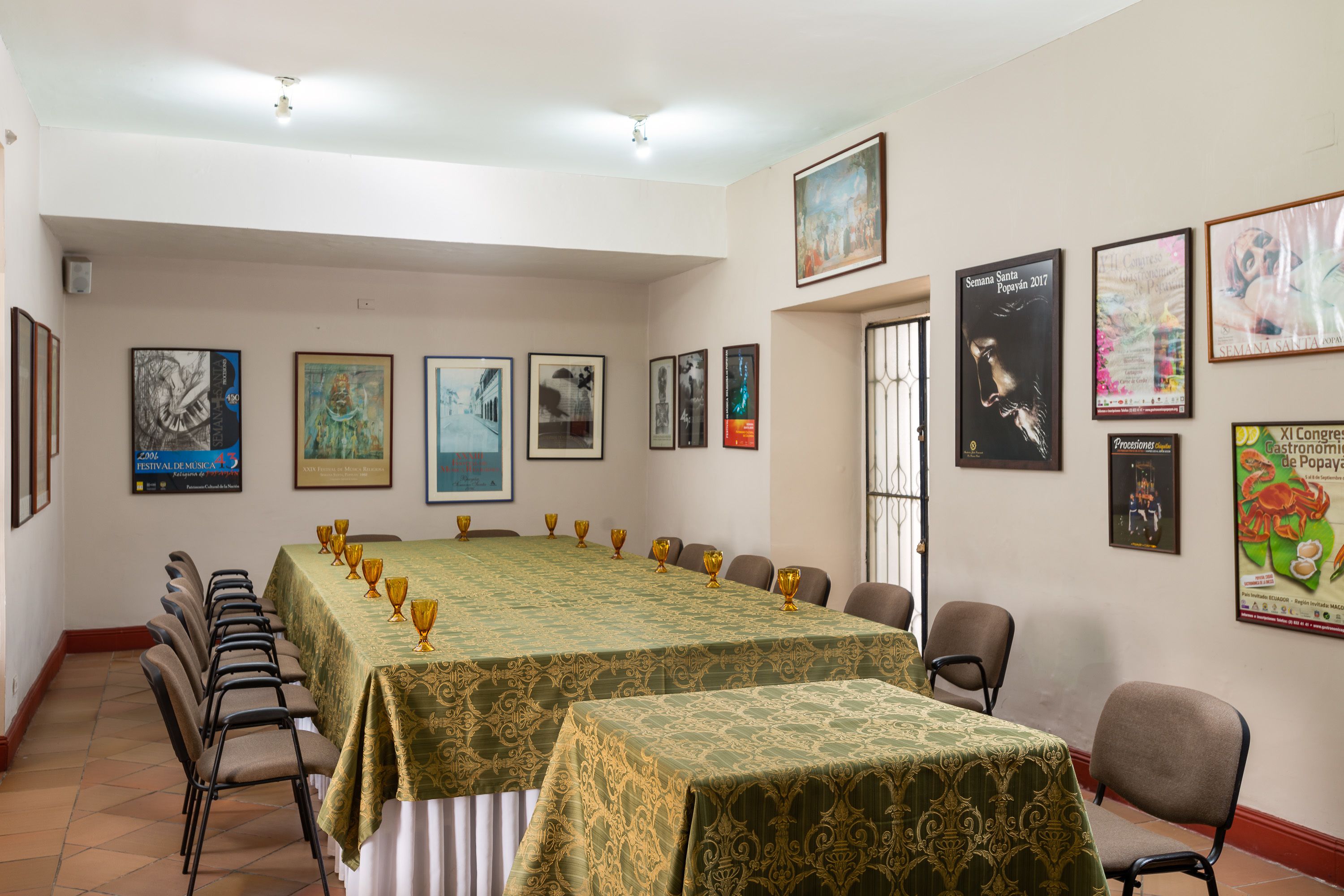 A conference room with a long table, chairs, and framed pictures on the walls.
