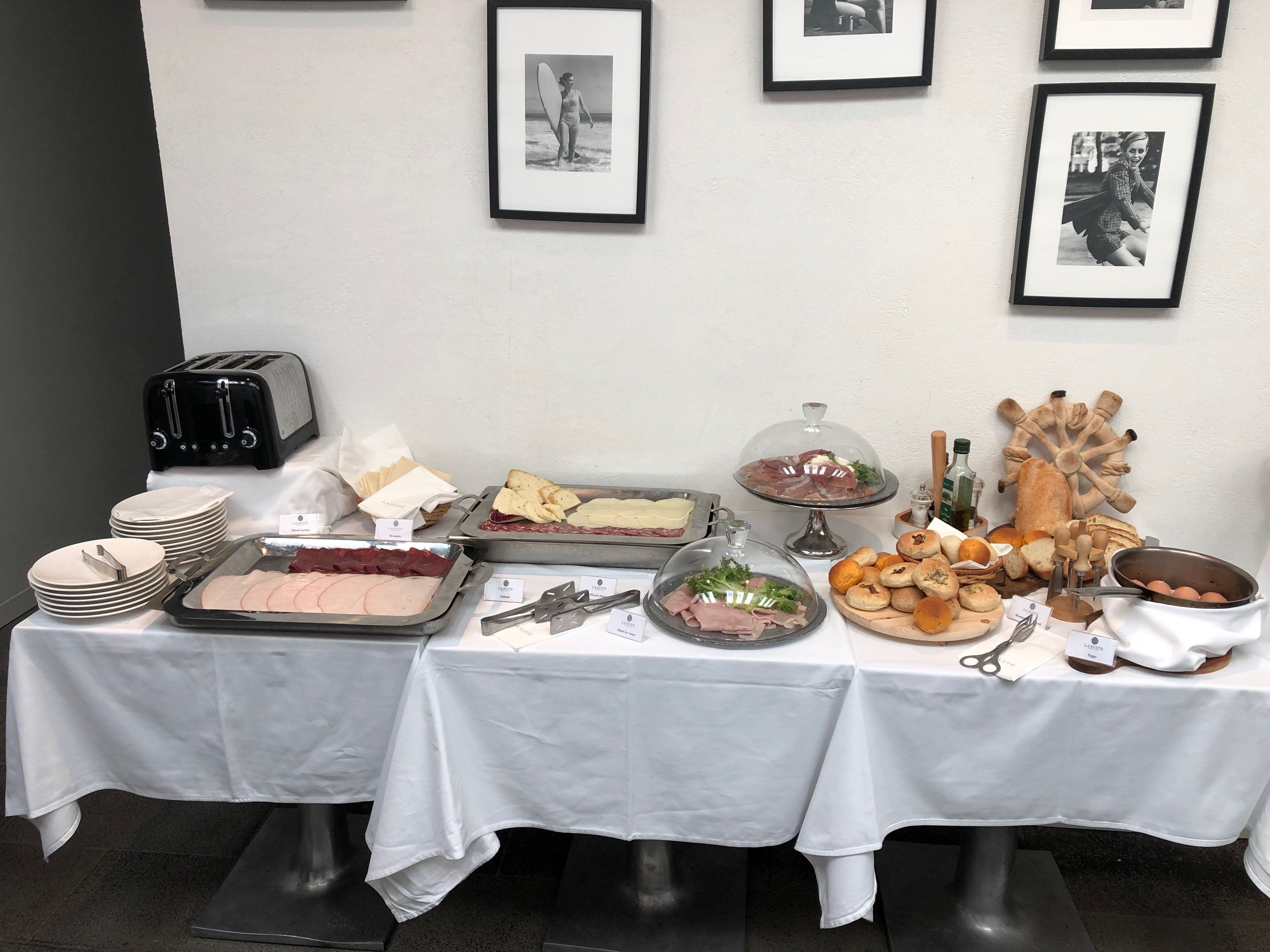 A buffet table with various food items, a toaster, and a decorative wheel.