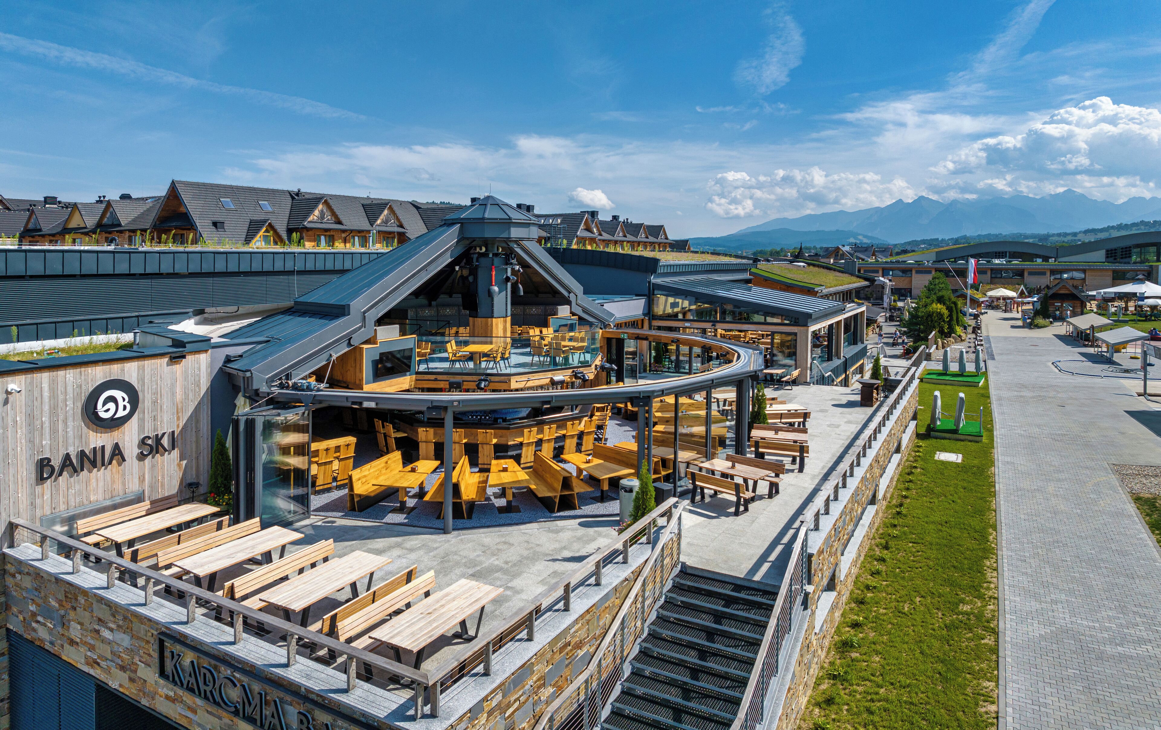 A modern ski resort with a restaurant and outdoor seating area.