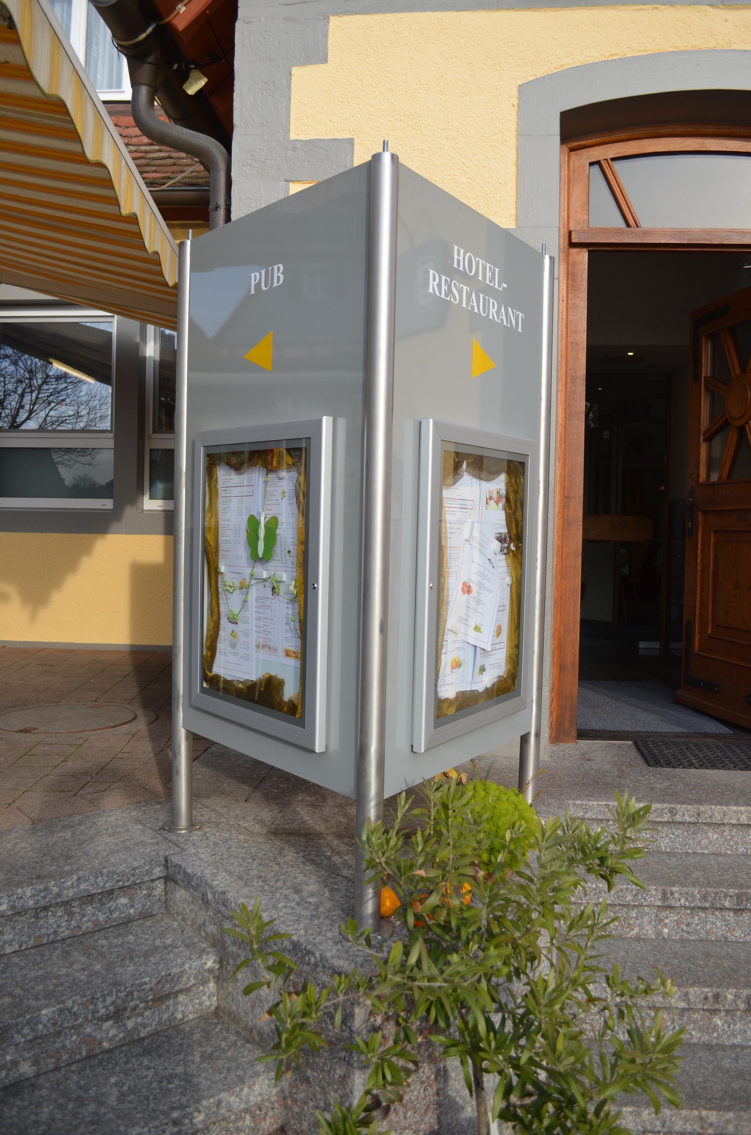 A signboard with 'PUB' and 'HOTEL-RESTAURANT' labels, indicating a pub and a hotel restaurant.