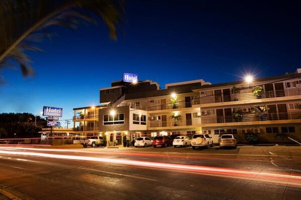 A hotel with multiple floors and a parking lot with several cars. - Hotel Mazatlan (Mazatlán)