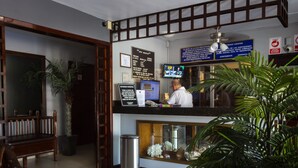 A hotel reception area with a reception desk, a monitor, and a signboard. - Hotel Mazatlan (Mazatlán)