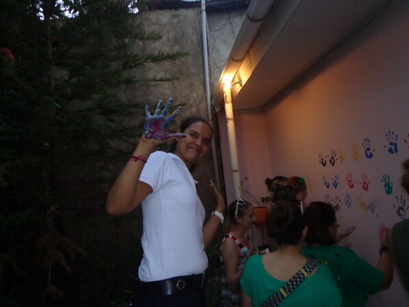 A person holding a colorful handprint.