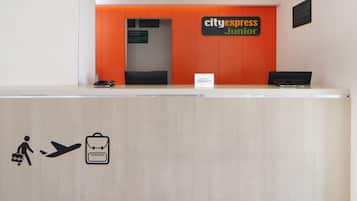 A reception desk with a sign reading "cityexpress junior" and a sign for "Marriott Bonvoy".
