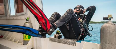 A diver on a boat preparing for a dive.