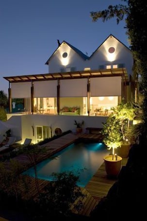 Outdoor pool, pool umbrellas, pool loungers. Four Rosmead