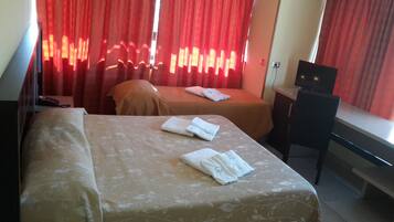 Triple Room | Minibar, individually furnished, desk, blackout drapes