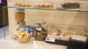 A buffet with various baked goods and snacks. - Hotel La Piana (Tito)
