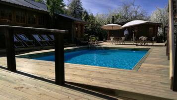 Seasonal outdoor pool, pool umbrellas, pool loungers