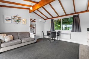 Self Contained Unit - 1 Bedroom Family (1BR) | Living area | 40-inch flat-screen TV with digital channels, TV - Tasman Holiday Parks - Te Anau (Te Anau)