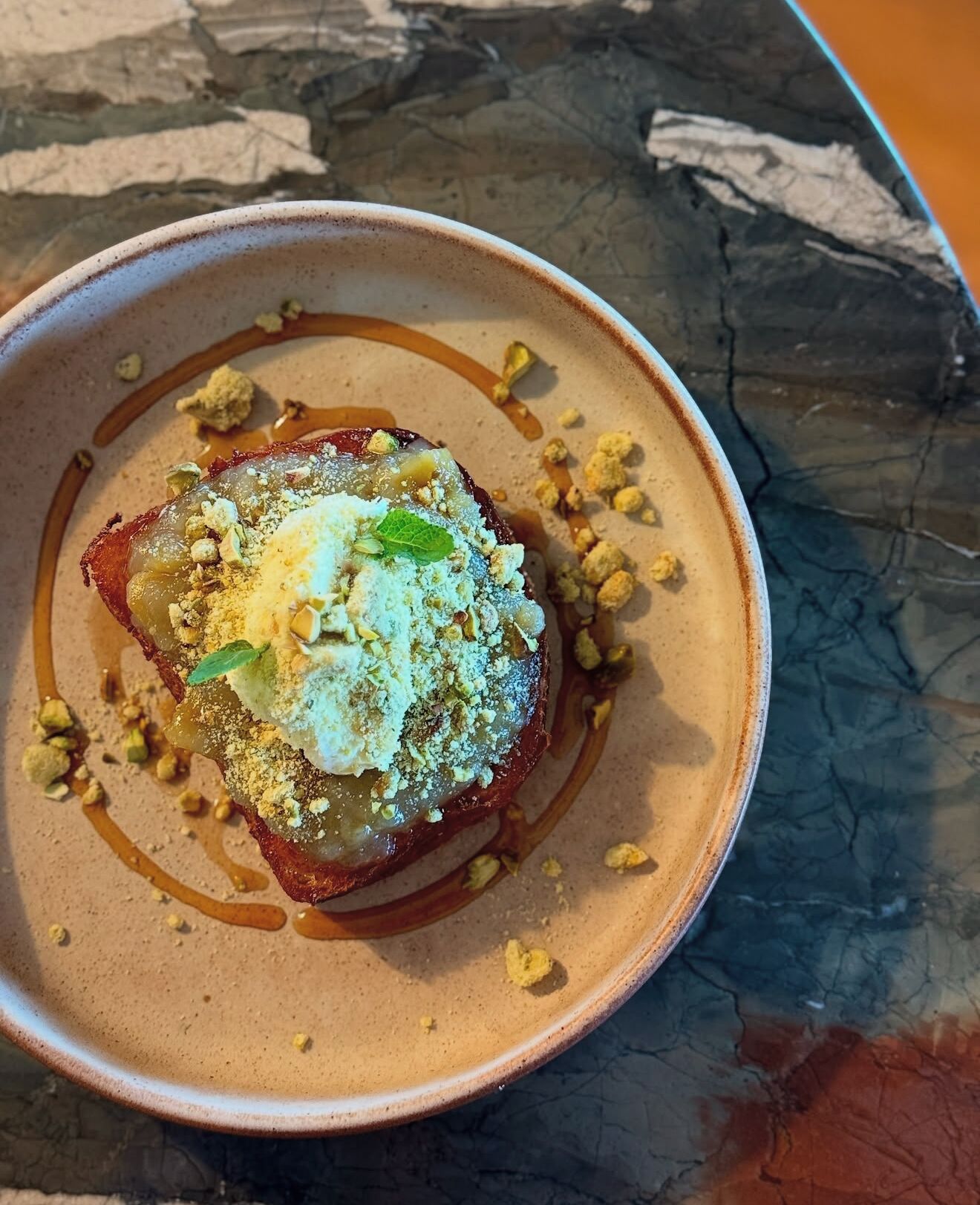 A dessert on a ceramic plate with a textured surface.