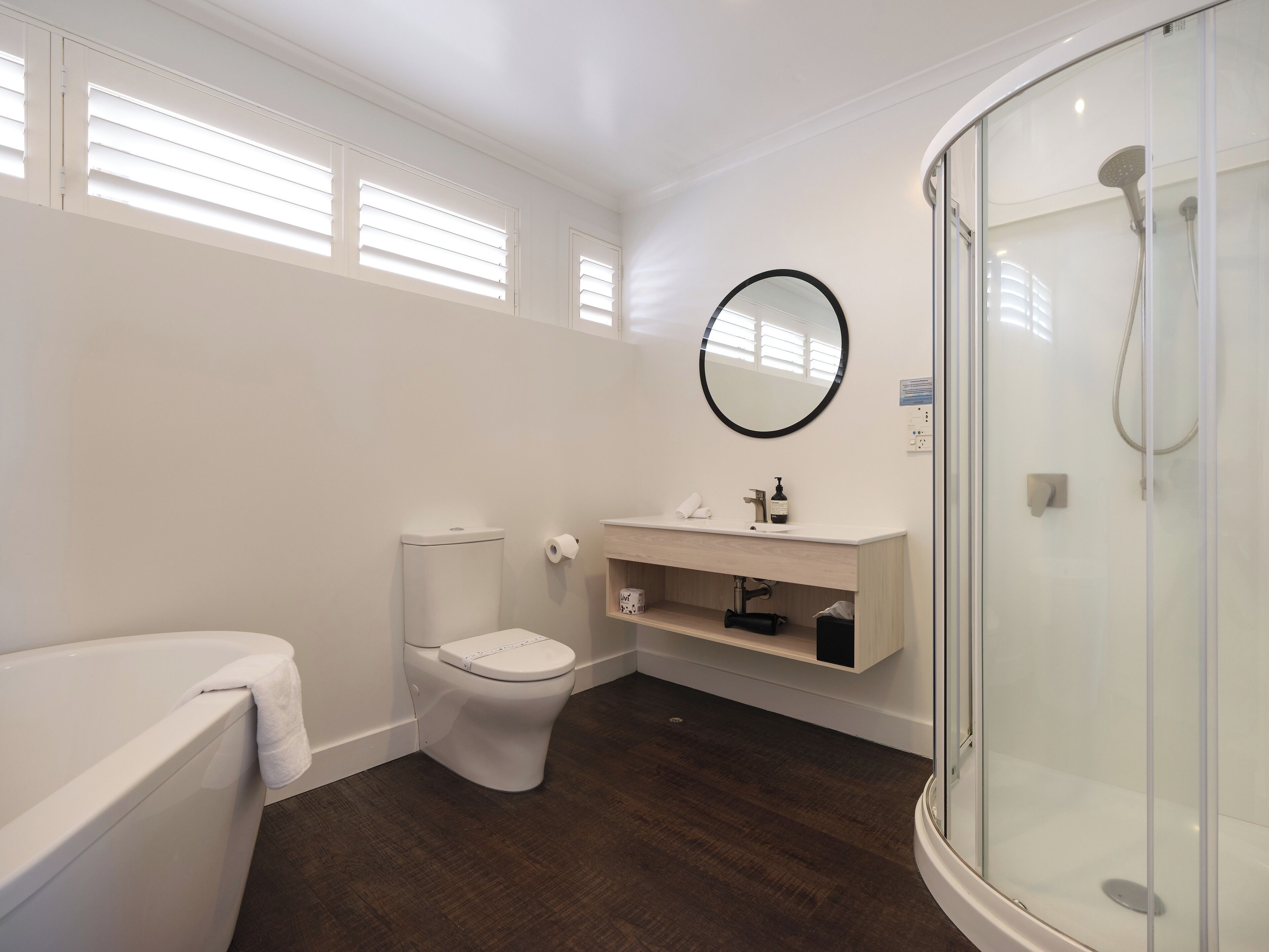 A bathroom with a toilet, sink, and shower.