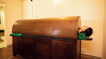 A wooden bench with a person lying on it.
