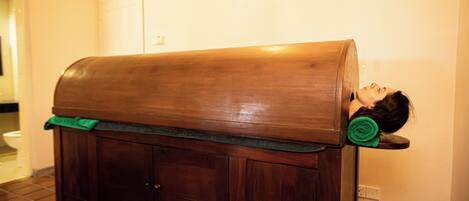 A wooden bench with a person lying on it.