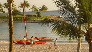 On the beach, white sand, sun-loungers, beach umbrellas