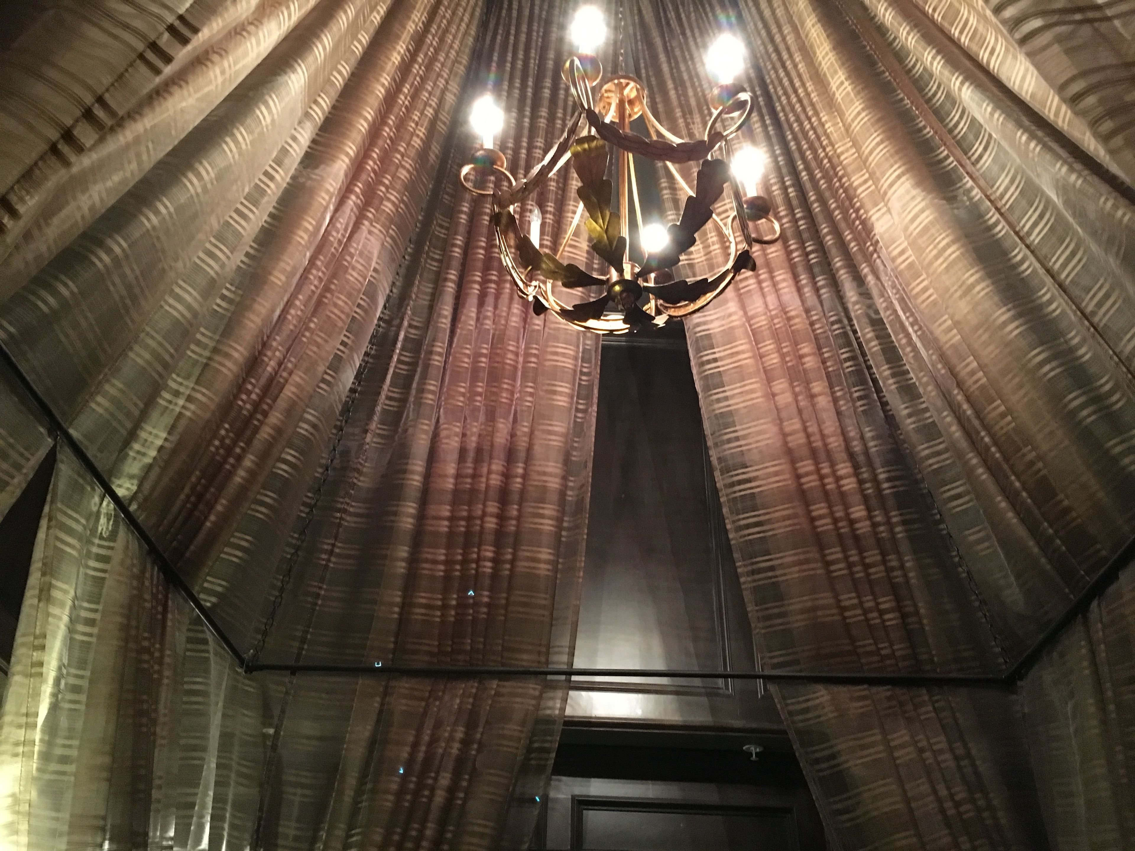 A room with a high ceiling and a chandelier.