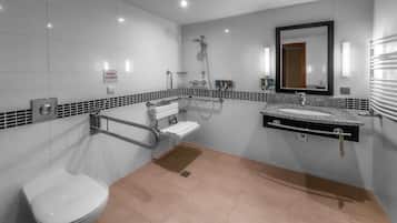 A modern bathroom with a toilet, sink, and shower.