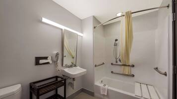 A modern bathroom with a toilet, sink, and shower area.