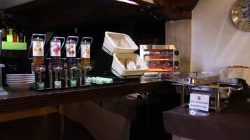 A buffet setup with various food items and a sign indicating 'Uva Strappazzate Scrambled Eggs'.