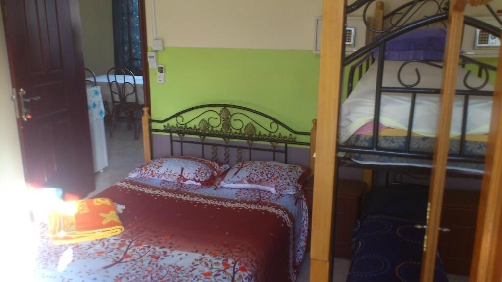 A room with a bed, a chair, and a table.