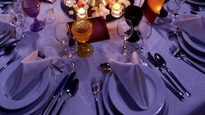 A table set for a formal dinner with candles, glasses, and cutlery. - A Coutada Hotel Rural (Peniche)