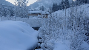A snow-covered landscape with a building in the background.