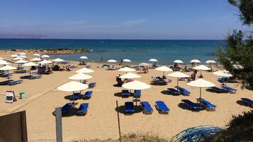 On the beach, sun loungers, beach umbrellas, beach volleyball