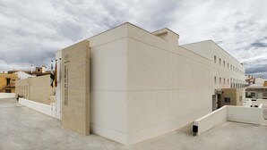 Een modern gebouw met een plat dak en een groot bord waarop 