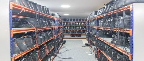 A server room with racks of equipment and cables.