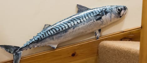 A fish sculpture on a staircase.
