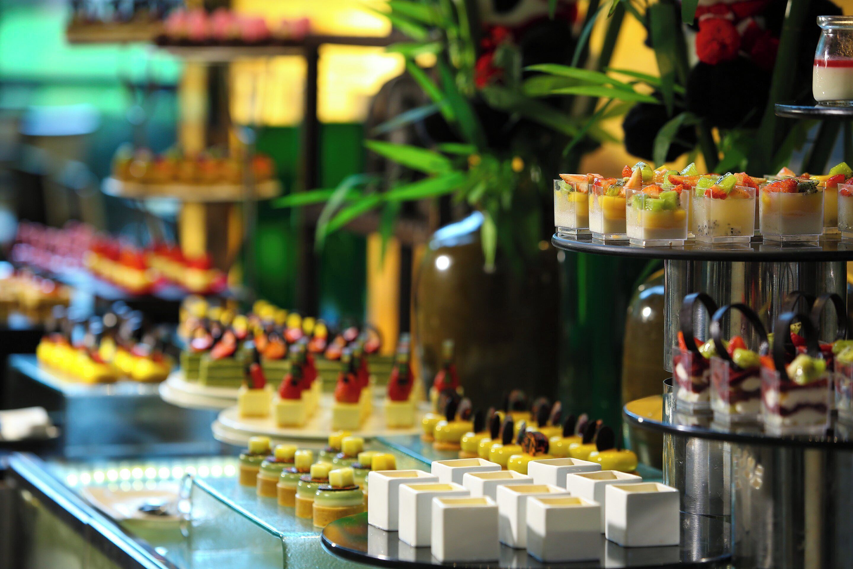 A buffet with various food items and desserts.