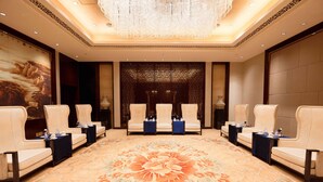 A hotel lobby with a floral carpet, seating areas, and a decorative wall. - Crowne Plaza Chengdu Panda Garden by IHG - Near Panda Base (Chengdu)
