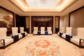 A hotel lobby with a floral carpet, seating areas, and a decorative wall. - Crowne Plaza Chengdu Panda Garden by IHG - Near Panda Base (Chengdu)
