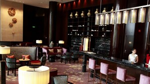 A hotel lobby with a bar area, seating arrangements, and a decorative wall. - Crowne Plaza Chengdu Panda Garden by IHG - Near Panda Base (Chengdu)