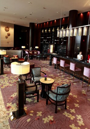 A hotel lobby with a bar area, seating arrangements, and a decorative wall. - Crowne Plaza Chengdu Panda Garden by IHG - Near Panda Base (Chengdu)