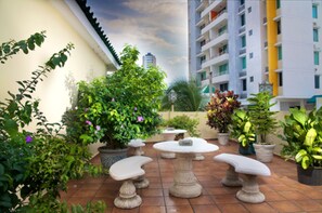 Guests can enjoy seating and greenery in this outdoor patio area.