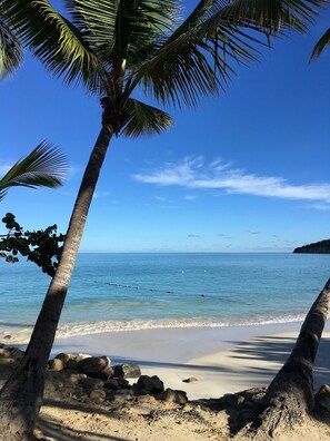 On the beach, white sand, sun loungers, beach towels