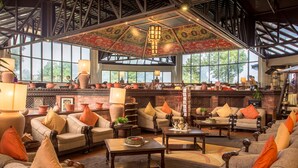 A spacious lounge with multiple seating areas, a fireplace, and large windows offering natural light. - Club Himalaya by ACE Hotels, Nagarkot  (Baluwapati Deupur)
