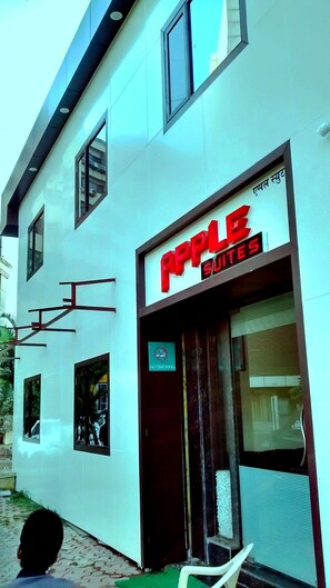 A building with a sign for "Apple Suites" indicating a hotel or accommodation. - Apple Suites (Mumbai)