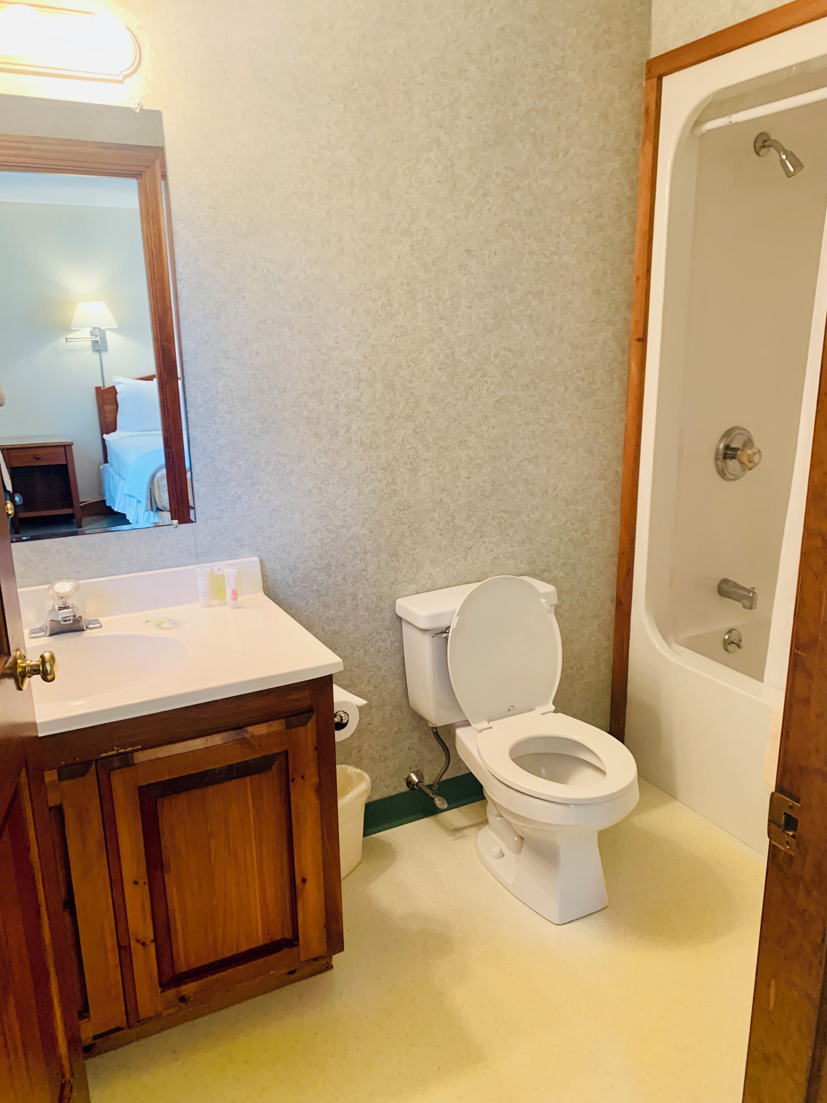A bathroom with a sink, toilet, and bathtub.