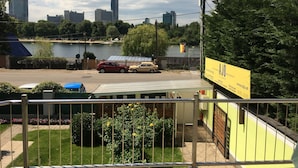 A view of a building with a yellow sign advertising apartments.