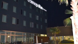 A hotel with a large illuminated sign reading "Cosmopolitan." It features multiple windows and a well-lit exterior. - Cosmopolitan Hotel (Civitanova Marche)